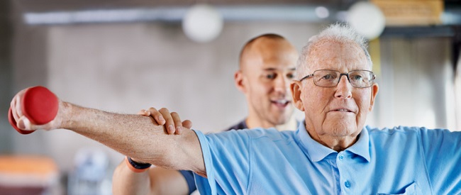 This is all you now! Physiotherapist helping a senior man with weights