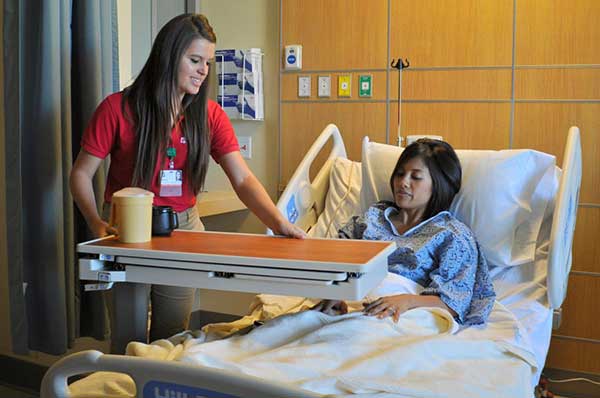 Staff helping a patient in a medical room